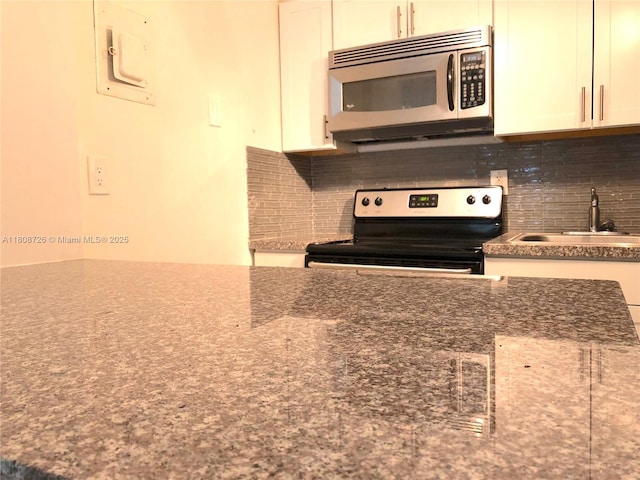 4301 NW S Tamiami Canal Dr Unit 3-209, Miami, FL 33126 - kitchen featuring appliances with stainless steel finishes, a sink, tasteful backsplash, and white cabinetry