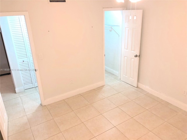 4301 NW S Tamiami Canal Dr Unit 3-209, Miami, FL 33126 - spare room featuring light tile patterned floors and baseboards