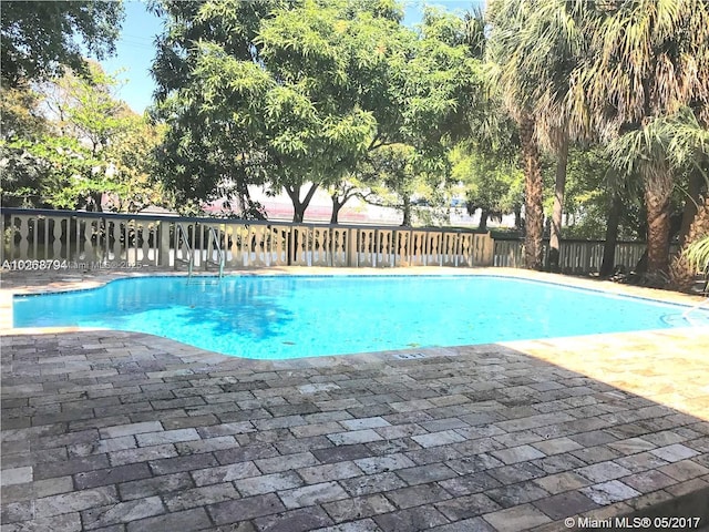 4301 NW S Tamiami Canal Dr Unit 3-209, Miami, FL 33126 - view of swimming pool featuring a patio