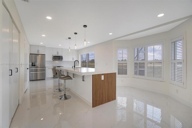 10728 Oak Lake Way, Boca Raton, FL 33498 - kitchen with appliances with stainless steel finishes, light marble finish flooring, recessed lighting, light countertops, and backsplash