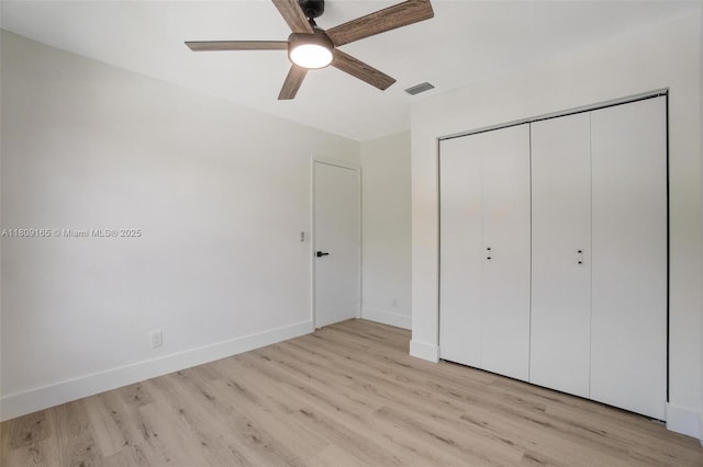 10728 Oak Lake Way, Boca Raton, FL 33498 - unfurnished bedroom featuring light wood-type flooring, baseboards, a closet, and a ceiling fan