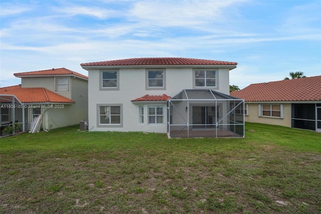 10728 Oak Lake Way, Boca Raton, FL 33498 - back of house featuring stucco siding, a lawn, central AC, a tile roof, and glass enclosure