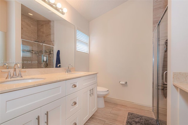 4815 Jefferson Rd, Delray Beach, FL 33445 - bathroom featuring double vanity, a shower stall, toilet, and baseboards