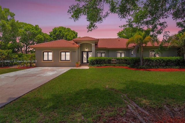 17375 SW 282nd St, Homestead, FL 33030 - mediterranean / spanish home with a tiled roof, stucco siding, a yard, and concrete driveway