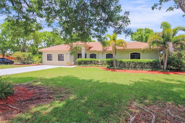 17375 SW 282nd St, Homestead, FL 33030 - mediterranean / spanish home featuring a tiled roof, a front yard, and stucco siding