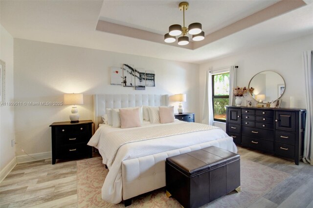 17375 SW 282nd St, Homestead, FL 33030 - bedroom featuring a chandelier, light wood-style floors, baseboards, and a raised ceiling