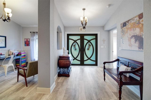 17375 SW 282nd St, Homestead, FL 33030 - entryway with a chandelier, wood finished floors, baseboards, and arched walkways