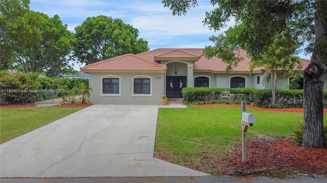 17375 SW 282nd St, Homestead, FL 33030 - mediterranean / spanish home featuring a tile roof, stucco siding, driveway, and a front yard