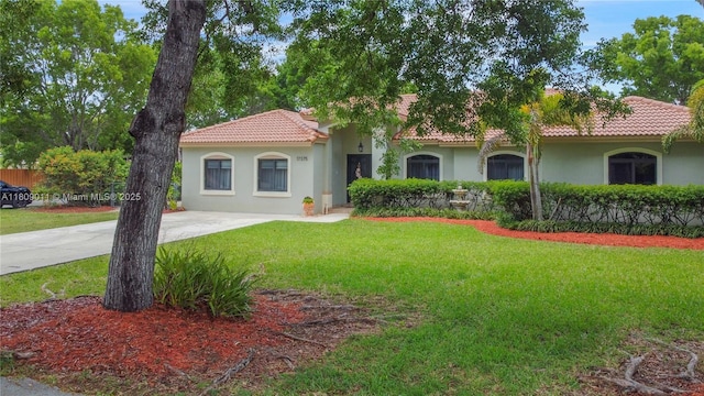 17375 SW 282nd St, Homestead, FL 33030 - mediterranean / spanish house featuring a tile roof, stucco siding, and a front yard