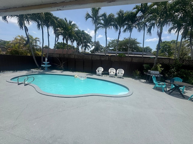 13320 SW 99th St, Miami, FL 33186 - view of pool featuring a patio area, a fenced backyard, and area for grilling