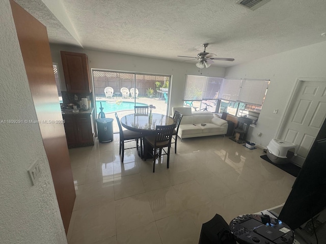 13320 SW 99th St, Miami, FL 33186 - dining room featuring a textured ceiling, a ceiling fan, and light tile patterned floors