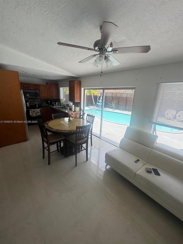 13320 SW 99th St, Miami, FL 33186 - dining room featuring a textured ceiling, ceiling fan, and light tile patterned flooring