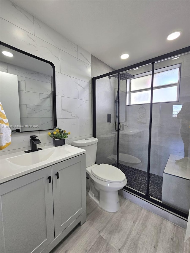 1490 NW 43rd Ave Unit 301, Lauderhill, FL 33313 - full bathroom featuring tile walls, vanity, toilet, wood finished floors, and a stall shower