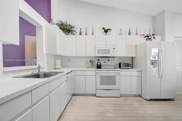 7713 Springwater Pl, Boynton Beach, FL 33437 - kitchen featuring white appliances, a sink, white cabinetry, light wood-style floors, and light countertops