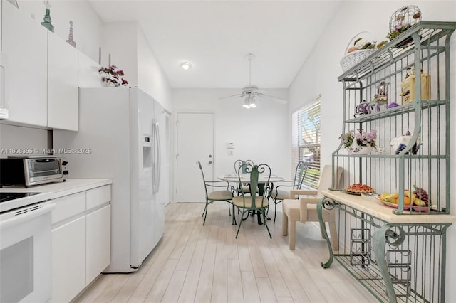 7713 Springwater Pl, Boynton Beach, FL 33437 - kitchen with white range with electric cooktop, a ceiling fan, white cabinets, light wood-type flooring, and light countertops