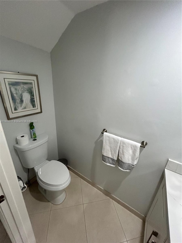 1051 Sorrento Dr, Weston, FL 33326 - bathroom with toilet, vaulted ceiling, tile patterned flooring, and baseboards