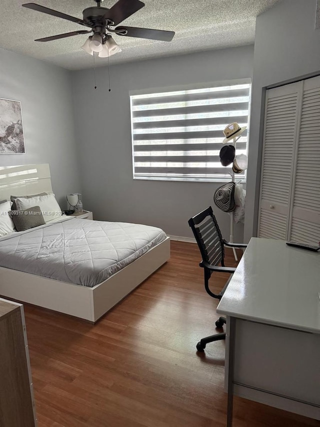 1051 Sorrento Dr, Weston, FL 33326 - bedroom with wood finished floors, a textured ceiling, a closet, a ceiling fan, and baseboards