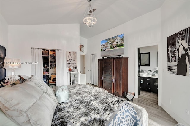 21388 Marina Cove Cir Unit 13-G, Aventura, FL 33180 - bedroom with wood finished floors, high vaulted ceiling, a chandelier, and baseboards
