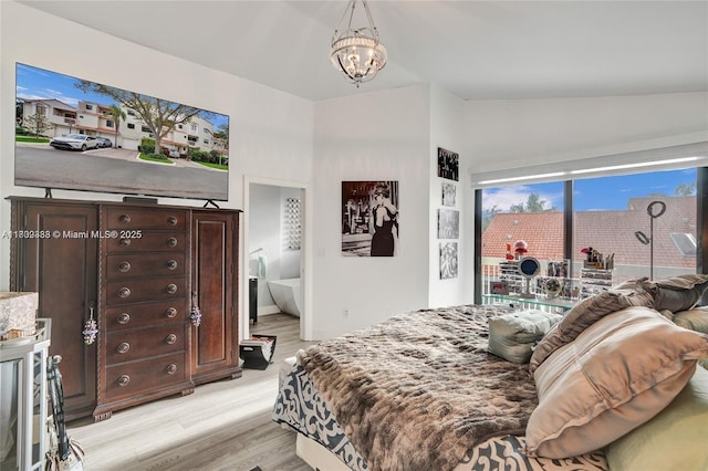21388 Marina Cove Cir Unit 13-G, Aventura, FL 33180 - bedroom featuring light wood-type flooring, access to exterior, a chandelier, and high vaulted ceiling