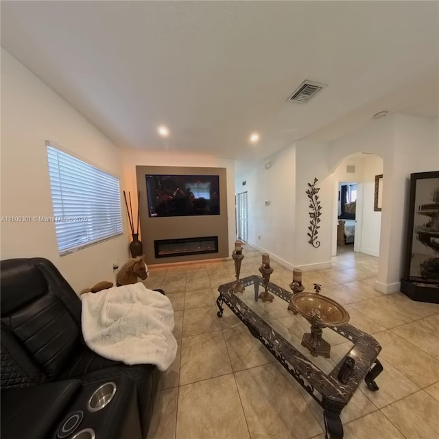 10341 SW 179th St, Miami, FL 33157 - living area featuring arched walkways, light tile patterned flooring, recessed lighting, a glass covered fireplace, and baseboards