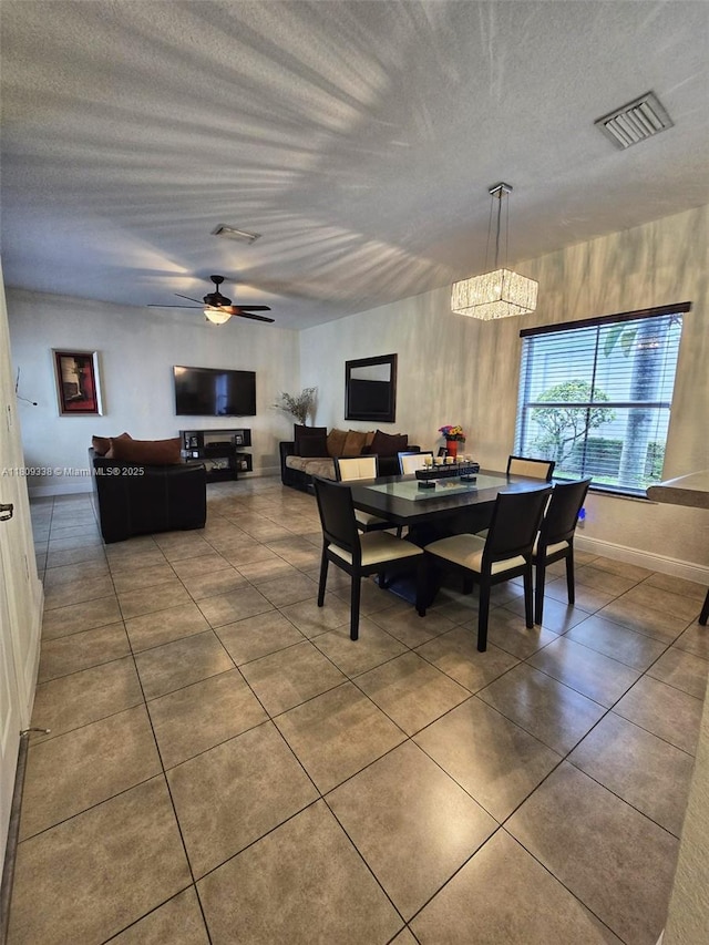 4940 SW 140th Ter Unit 14, Miramar, FL 33027 - dining room featuring tile patterned floors, a ceiling fan, a textured ceiling, and baseboards