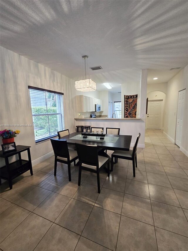 4940 SW 140th Ter Unit 14, Miramar, FL 33027 - tiled dining area with baseboards and a textured ceiling