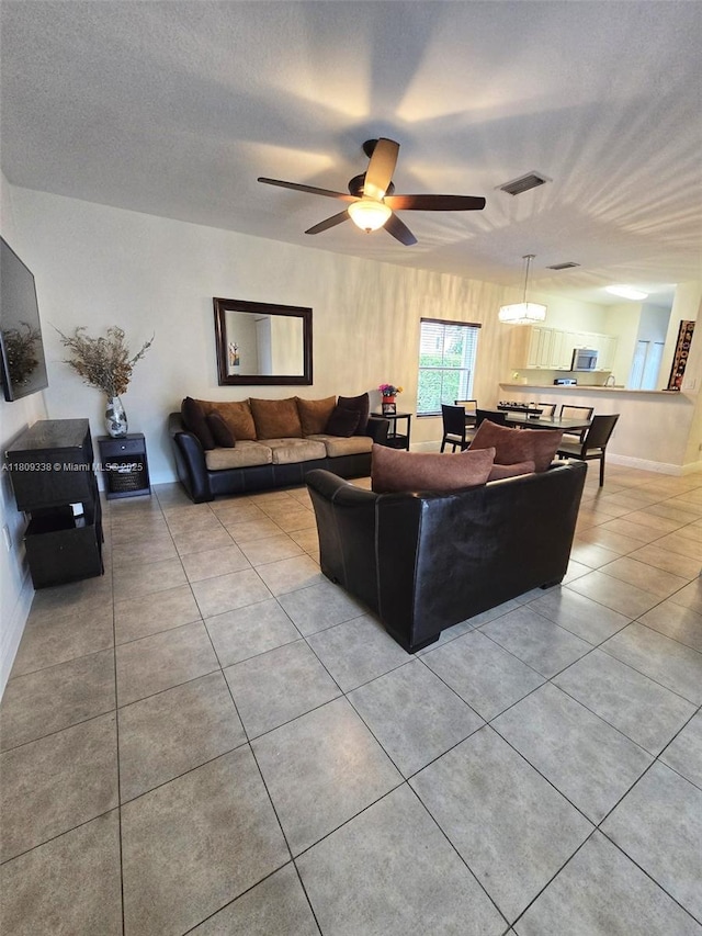 4940 SW 140th Ter Unit 14, Miramar, FL 33027 - living room featuring light tile patterned flooring, a ceiling fan, and baseboards