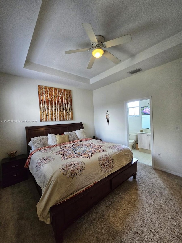 4940 SW 140th Ter Unit 14, Miramar, FL 33027 - carpeted bedroom featuring a raised ceiling, a textured ceiling, ensuite bathroom, a ceiling fan, and baseboards
