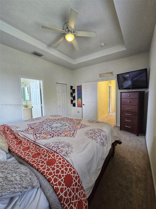 4940 SW 140th Ter Unit 14, Miramar, FL 33027 - bedroom featuring a tray ceiling, carpet flooring, a closet, ceiling fan, and ensuite bathroom