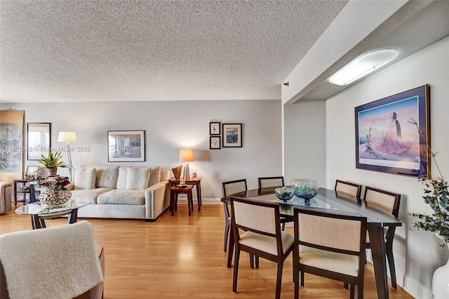 1201 S Ocean Dr Unit 609S, Hollywood, FL 33019 - dining room featuring a textured ceiling and light wood-style floors