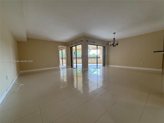 9255 SW 125th Ave Unit 304R, Miami, FL 33186 - empty room featuring a chandelier and light tile patterned flooring