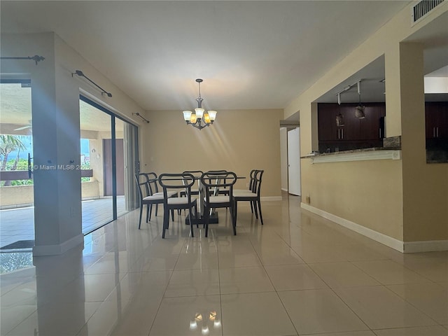 9255 SW 125th Ave Unit 304R, Miami, FL 33186 - tiled dining area with a chandelier and baseboards