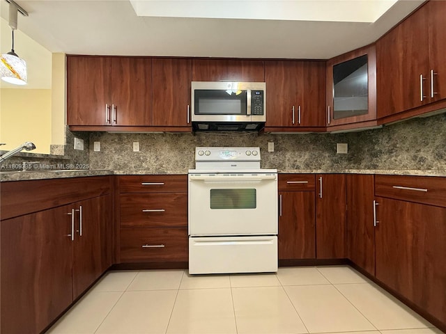 9255 SW 125th Ave Unit 304R, Miami, FL 33186 - kitchen with stainless steel microwave, white electric stove, backsplash, glass insert cabinets, and light tile patterned flooring