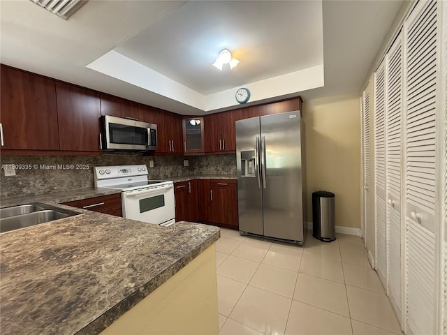 9255 SW 125th Ave Unit 304R, Miami, FL 33186 - kitchen with appliances with stainless steel finishes, a raised ceiling, light tile patterned floors, and backsplash