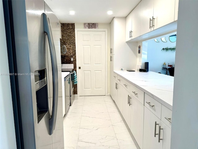 9725 NW 52nd St Unit 421, Doral, FL 33178 - kitchen featuring stainless steel appliances, light marble finish flooring, recessed lighting, white cabinetry, and light stone counters