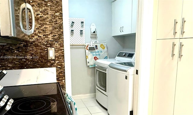 9725 NW 52nd St Unit 421, Doral, FL 33178 - laundry room featuring washing machine and clothes dryer, light tile patterned flooring, and cabinet space