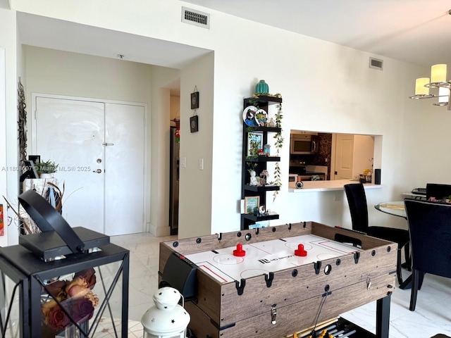 9725 NW 52nd St Unit 421, Doral, FL 33178 - recreation room with light marble finish flooring and a chandelier