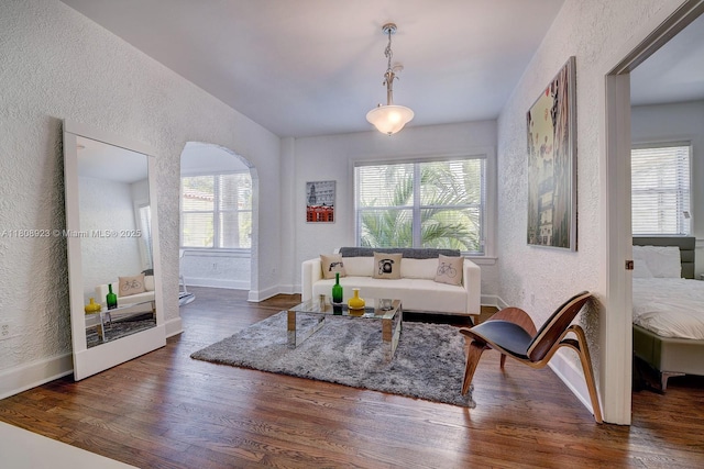 900 16th St Unit 204, Miami Beach, FL 33139 - living area featuring a textured wall, baseboards, wood finished floors, and vaulted ceiling
