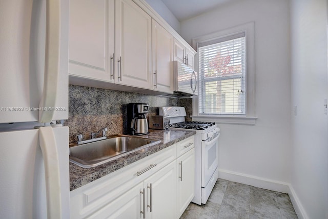 900 16th St Unit 204, Miami Beach, FL 33139 - kitchen with white appliances, a sink, baseboards, and white cabinets