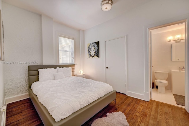 900 16th St Unit 204, Miami Beach, FL 33139 - bedroom with baseboards, wood finished floors, and connected bathroom