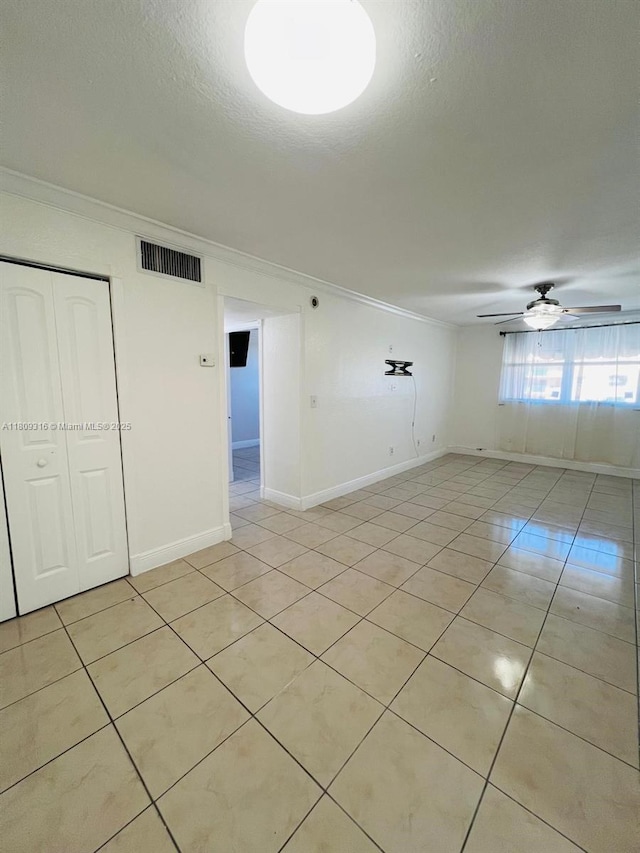 606 W 81st St Unit 224, Hialeah, FL 33014 - empty room featuring ornamental molding, light tile patterned floors, a ceiling fan, a textured ceiling, and baseboards