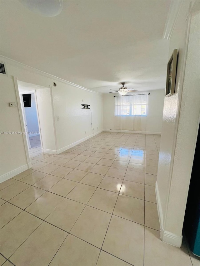 606 W 81st St Unit 224, Hialeah, FL 33014 - unfurnished room with ceiling fan, light tile patterned flooring, baseboards, and ornamental molding