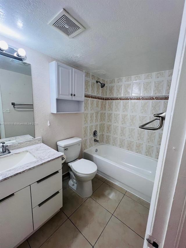 606 W 81st St Unit 224, Hialeah, FL 33014 - bathroom with toilet, vanity, washtub / shower combination, tile patterned floors, and a textured ceiling