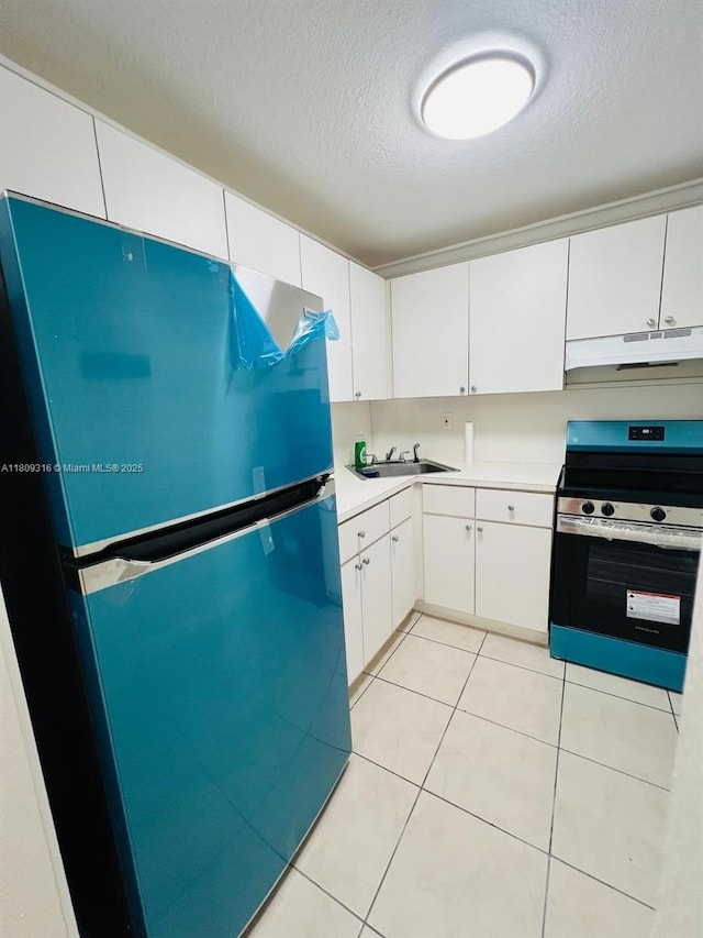 606 W 81st St Unit 224, Hialeah, FL 33014 - kitchen featuring stainless steel range with electric stovetop, freestanding refrigerator, under cabinet range hood, light countertops, and a textured ceiling