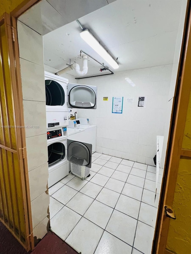 606 W 81st St Unit 224, Hialeah, FL 33014 - communal laundry room featuring stacked washing machine and dryer, washing machine and dryer, and light tile patterned flooring