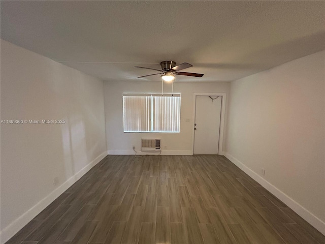 17 NE 2nd Ave Unit 108, Dania Beach, FL 33004 - spare room featuring dark wood-style flooring, ceiling fan, a wall mounted AC, and baseboards