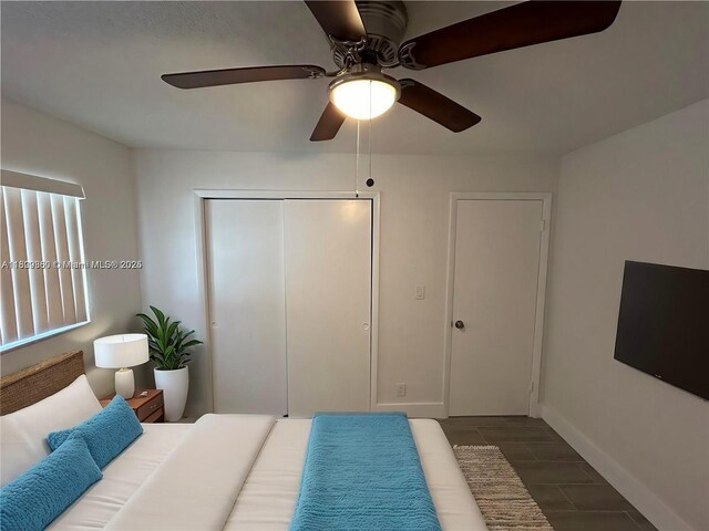 17 NE 2nd Ave Unit 108, Dania Beach, FL 33004 - unfurnished bedroom featuring baseboards, a closet, a ceiling fan, wood finished floors, and a textured ceiling