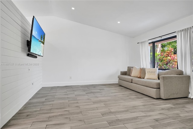 6933 SW 152nd Ct, Miami, FL 33193 - living room with vaulted ceiling, light wood-type flooring, recessed lighting, baseboards, and wood walls