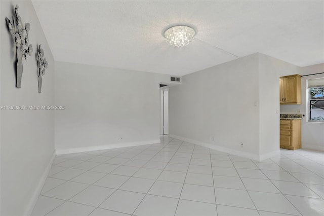 481 Durham Q Unit 481, Deerfield Beach, FL 33442 - spare room with light tile patterned floors, baseboards, a chandelier, and a textured ceiling