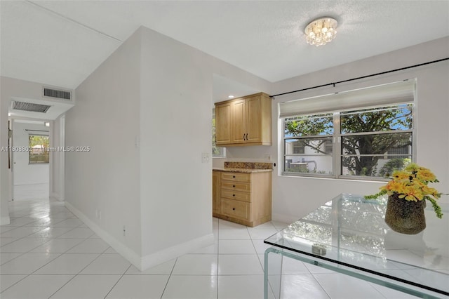 481 Durham Q Unit 481, Deerfield Beach, FL 33442 - kitchen with healthy amount of natural light, light tile patterned floors, baseboards, and a textured ceiling